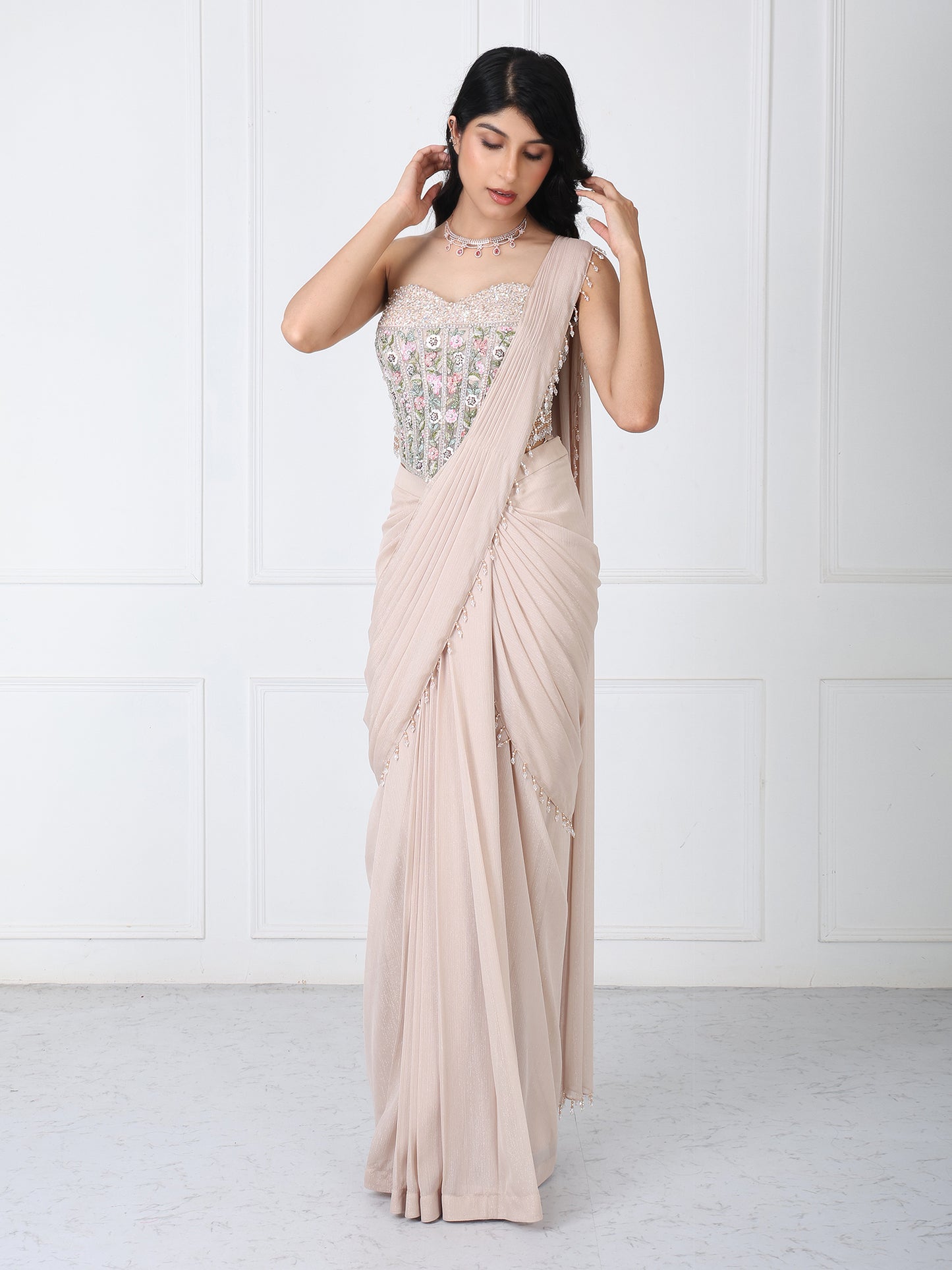 Beige drape saree with floral embroidered corset