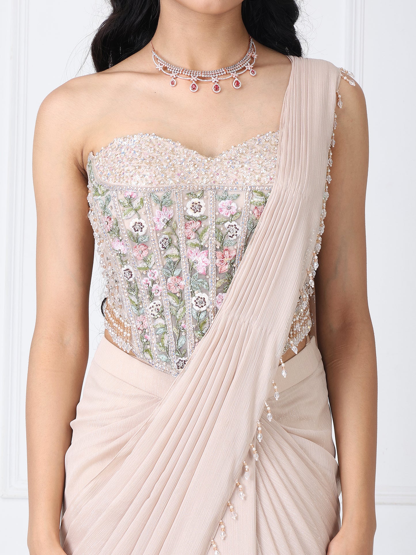 Beige drape saree with floral embroidered corset